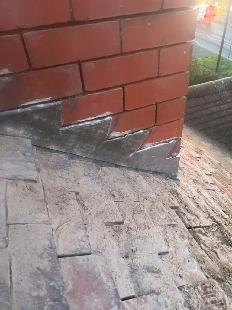 This is a photo of new leadwork being installed around an old chimney. Works carried out by Smethwick Roofing Repairs